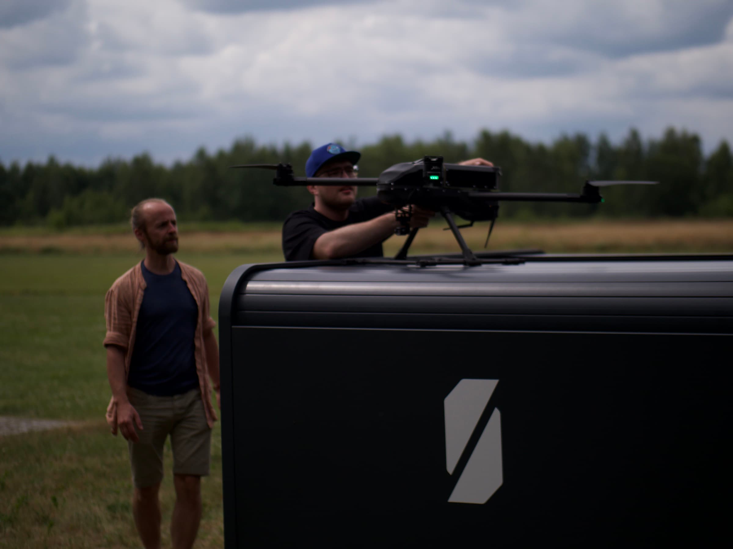 Operator placing a drone onto the Dronehub Monitoring Hub dock for autonomous battery swap