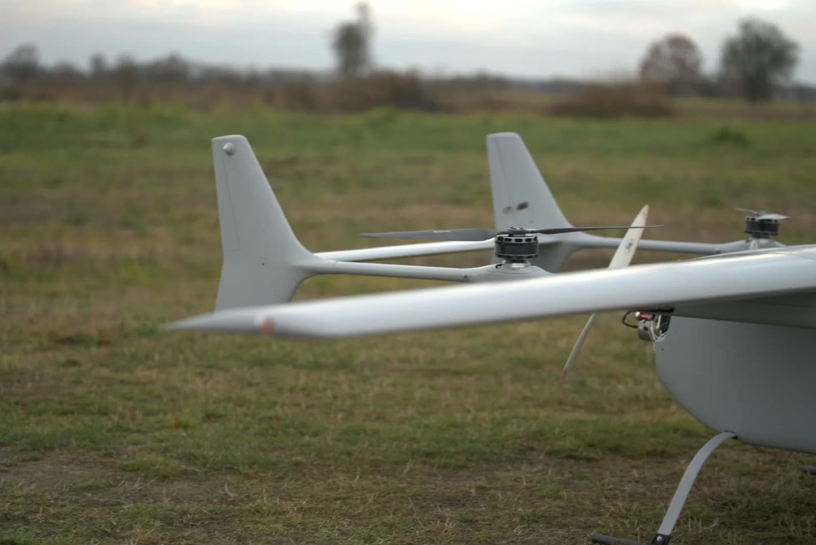 S-2 Combat Drone on the ground, full wingspan with the four wing-mounted VTOL rotors visible.